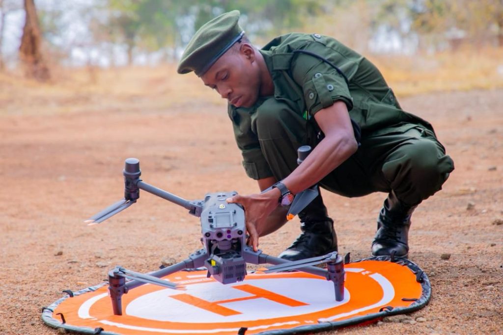 A TANAPA ranger working on setting up the Drone for Conservation Efforts