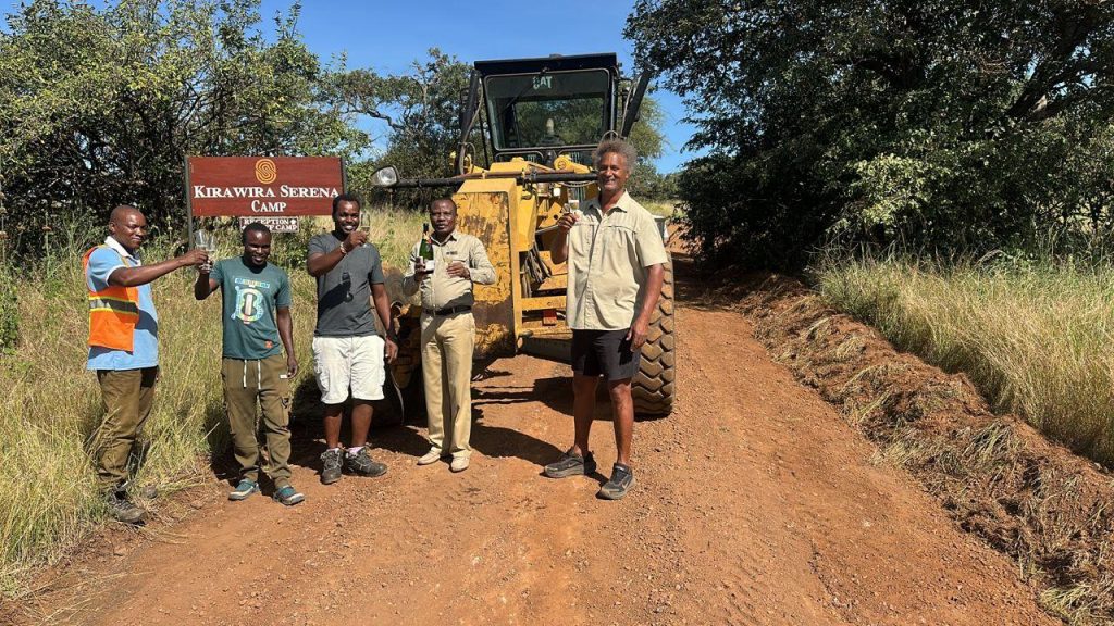 Mr Chambulo, TATO Chairman Celebrating With Serengeti Road Maintenance Project Workers